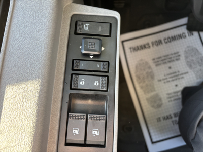 Truck door control panel with window and lock switches in a Mack PI64 interior showing L/R, window controls, and lock/unlock buttons.