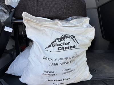Truck cab interior showing a Glacier Chains bag with stock number H2249SC CAMS 1 Pair Singles and tire sizes 10.00R20 11R24.5 285/75R24.5.