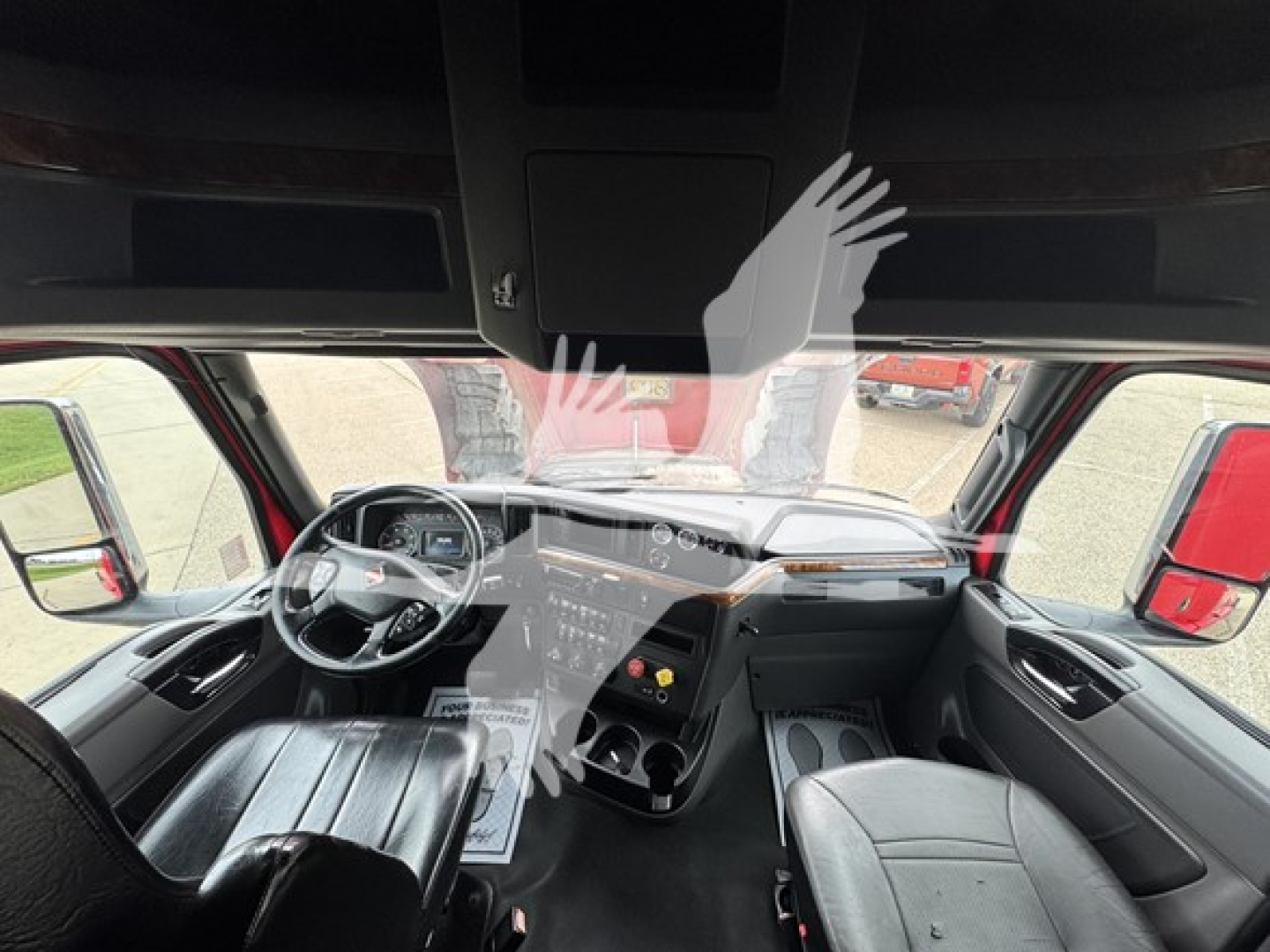 Interior of a 2019 International LT truck cab showing dashboard, steering wheel, and front seats.