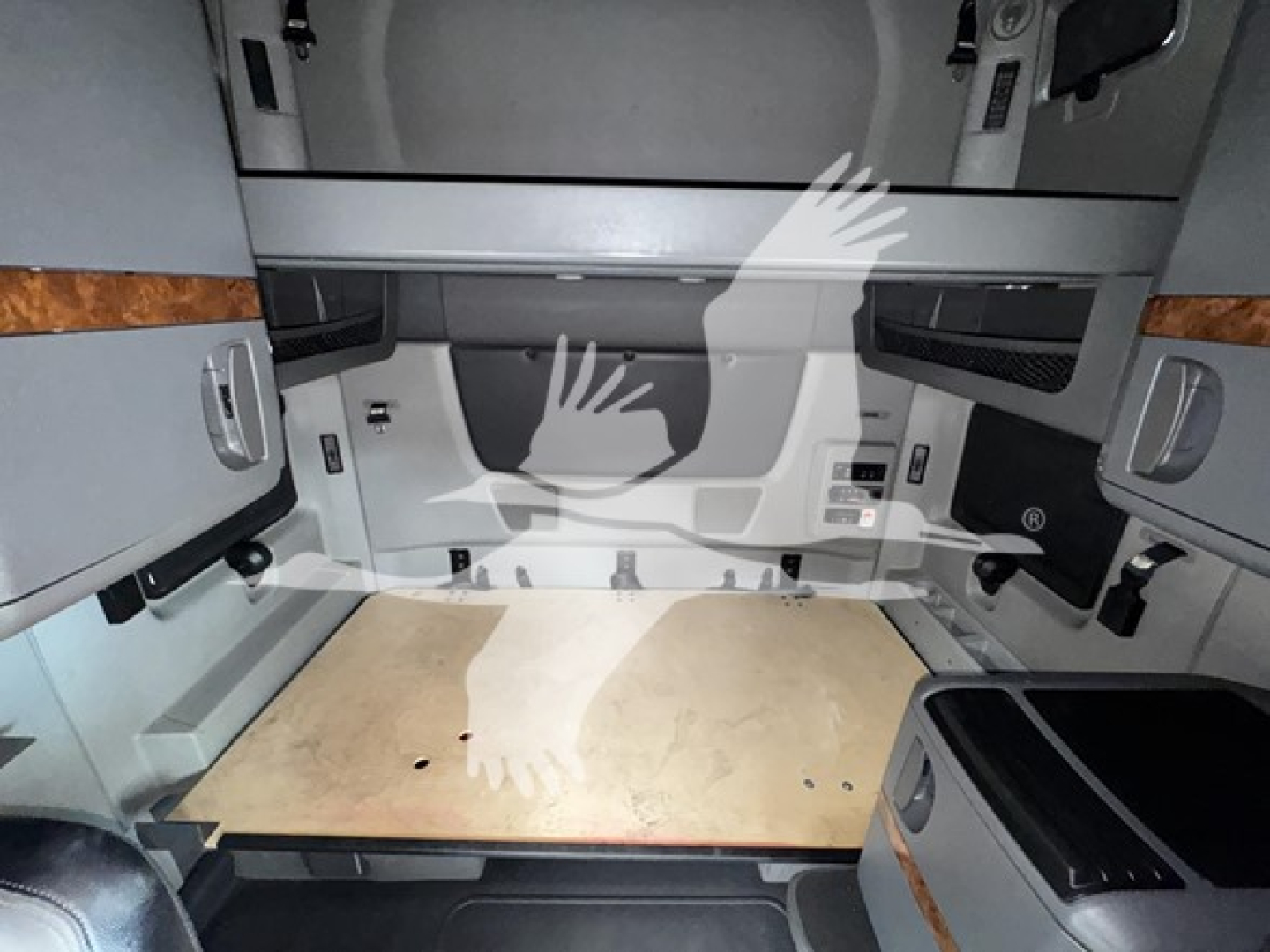 Interior sleeper cab cargo area of a 2019 International LT showing a wooden platform and side storage compartments.