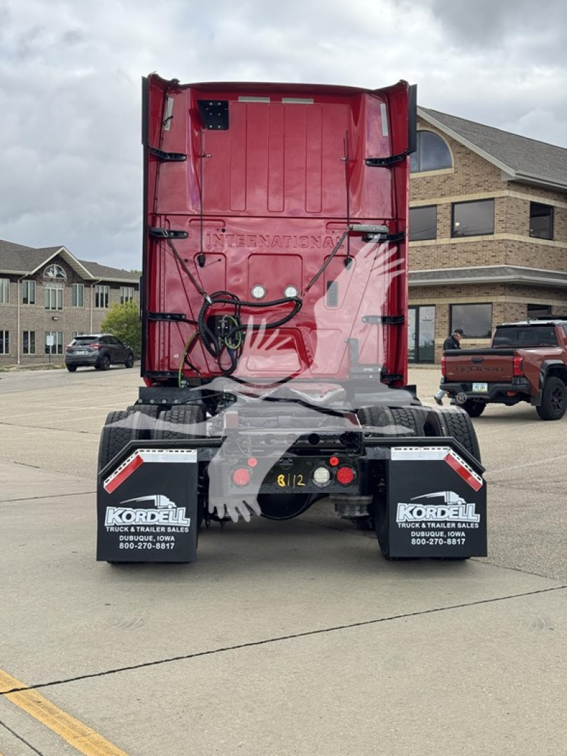Rear view of a red 2019 International LT sleeper truck showing rear bumper, mud flaps, and hitch area.