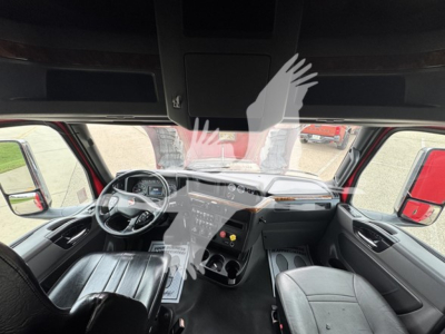 Interior of a 2019 International LT truck cab showing dashboard, steering wheel, and front seats.