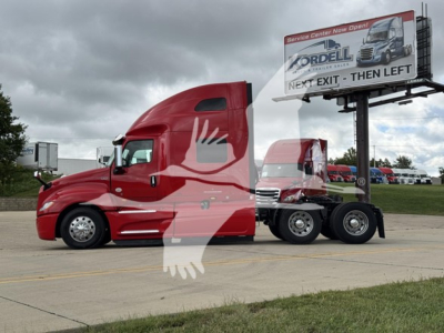 Truck cab and trailer from side showing red 2019 International LT, semi tractor with sleeper cab, billboard in background, stock number 2508112.