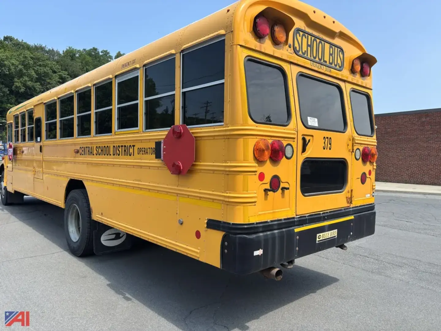 Back view of a yellow 2018 Blue Bird BBCVB 3011 school bus with School Bus signage, rear lights, and operator decals.