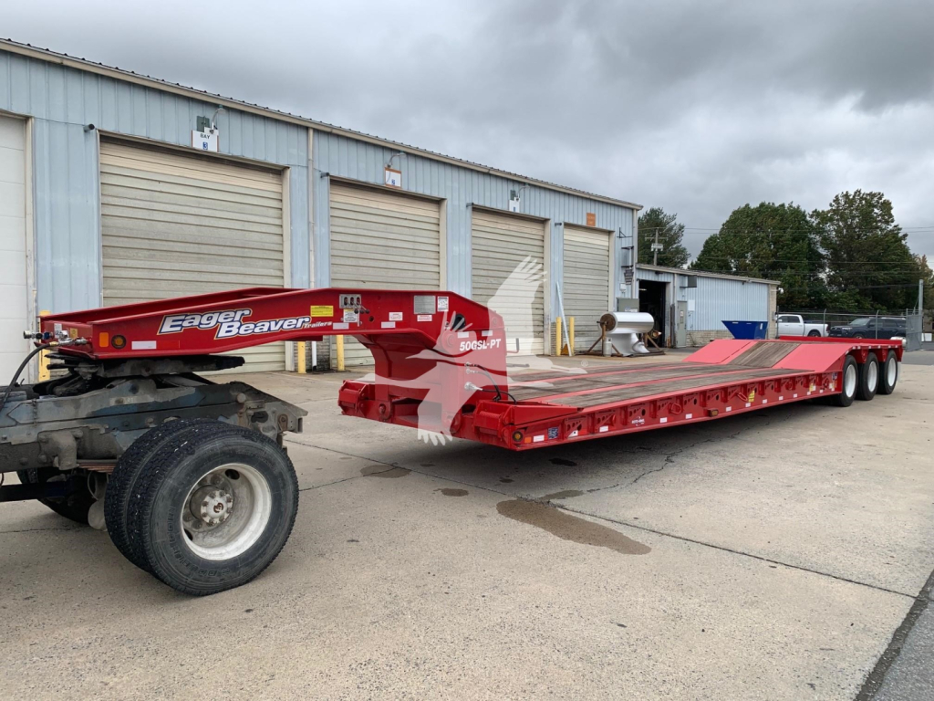 Eager Beaver 50Gsl-Pt lowboy trailer connected to a tractor showing brand name Eager Beaver on the front with red color and long flatbed.