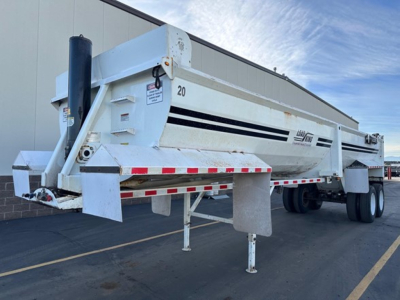 Load King RH32-29 dump trailer in side view showing white body with black stripes and landing legs.