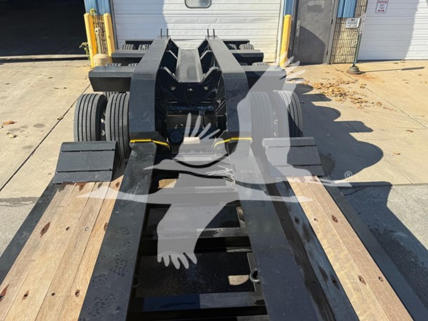Michelin Fontaine Magnitude 60HD MDSR lowboy trailer chassis showing fifth-wheel gooseneck area and wooden deck planks.