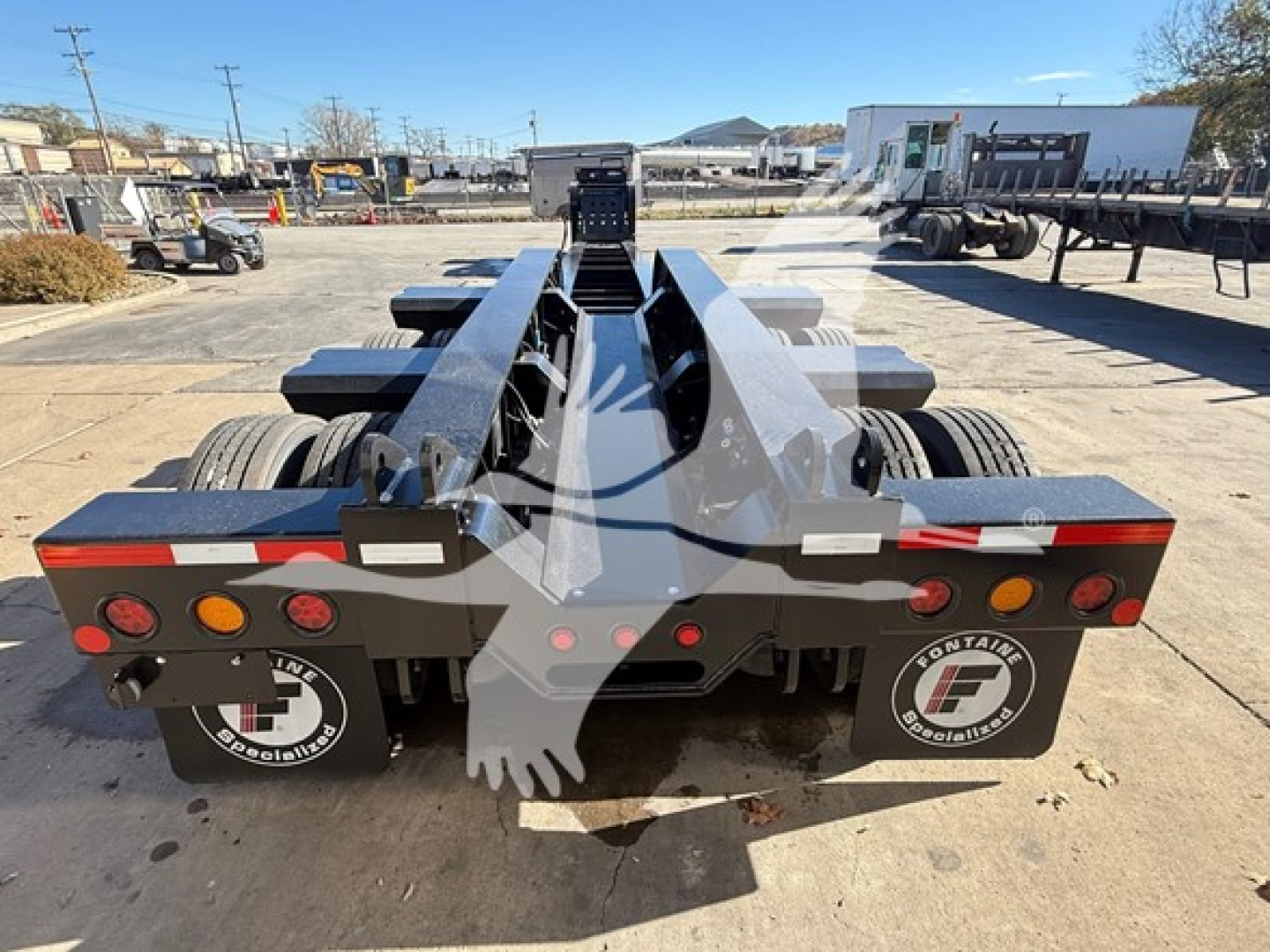 Fontaine Magnitude trailer chassis rear view showing dual axles and landing gear, with round taillights and reflectors.
