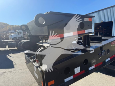 Hauling trailer deck showing hydraulic gooseneck and storage compartments with labels and warning stickers.