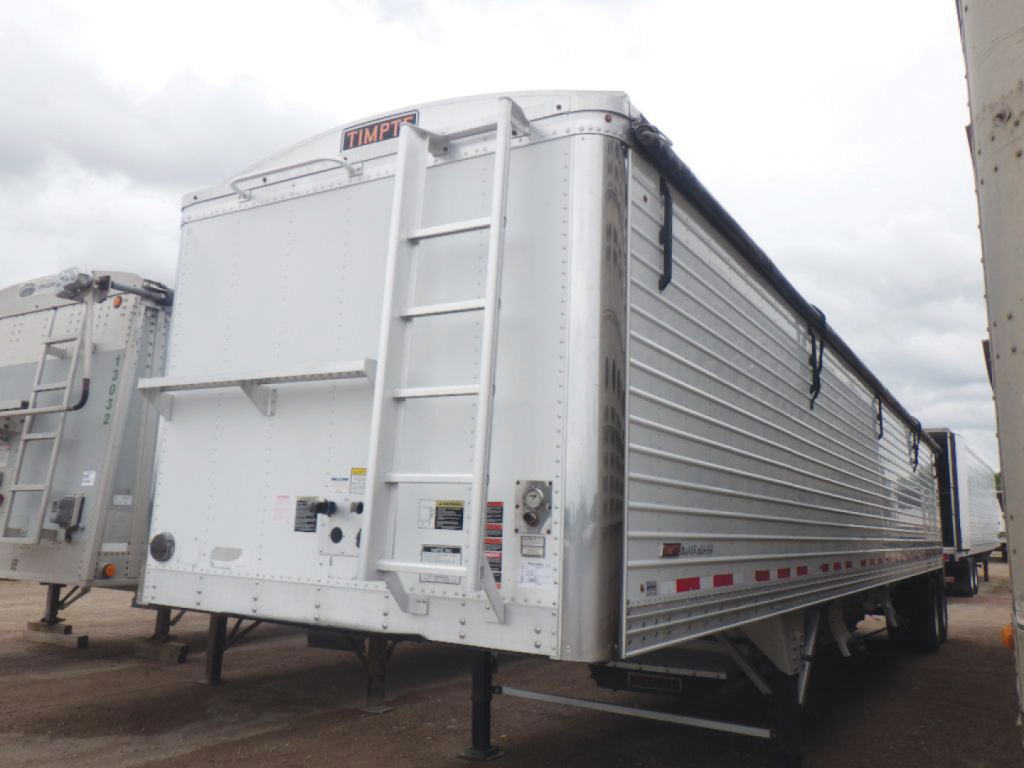 Timpte 2018 Super Hopper trailer rear view showing ladder and hinged tailgate and aluminum side paneling with reflective tape.