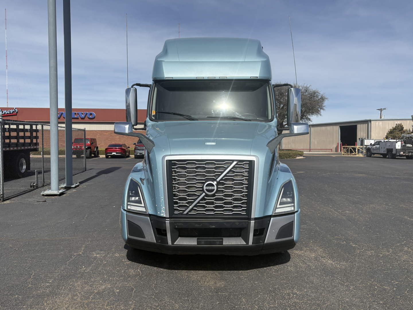 Front view of a light blue 2022 Volvo VNL64T760 conventional sleeper truck showing grille and Volvo logo.