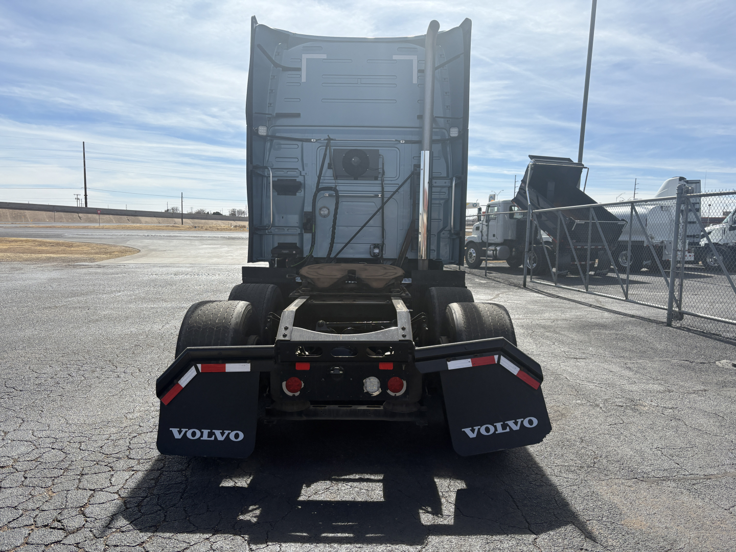 Volvo VNL64T760 truck rear view showing fenders, chassis, and spare tires with Volvo branding.
