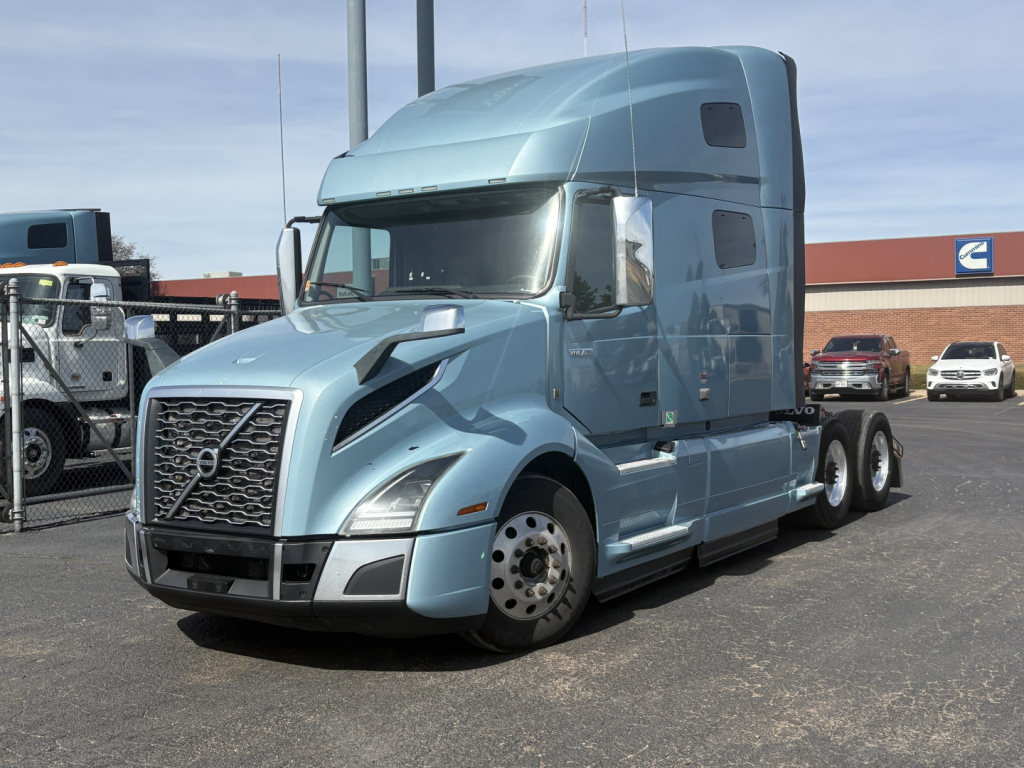 Volvo VNL64T760 sleeper cab tractor in light blue, side view showing aerodynamic hood and dual rear axles.