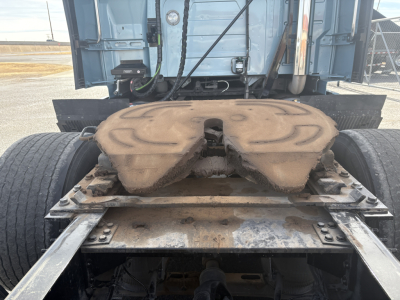 Volvo truck fifth wheel and rear drivetrain view showing mounting plate and air lines.