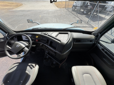 Volvo VNL64T760 truck interior dashboard and steering wheel with dual front seats visible.