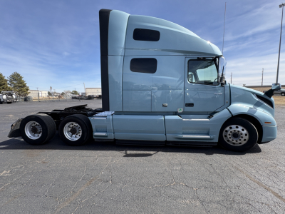 Volvo VNL64T760 tractor in-profile view showing sleeper cab and tandem rear axles.