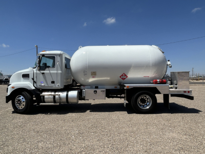 MacK MD7 truck side view with large cylindrical tank on chassis and tank decals visible