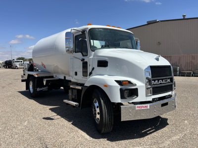 Front-left view of a white 2026 Mack MD7 tanker truck showing the cab, chrome grille with MACK emblem, and PROPANE label on the front bumper. Visible text includes MACK on grille and PROPANE on license-plate area; side mirrors and steps are