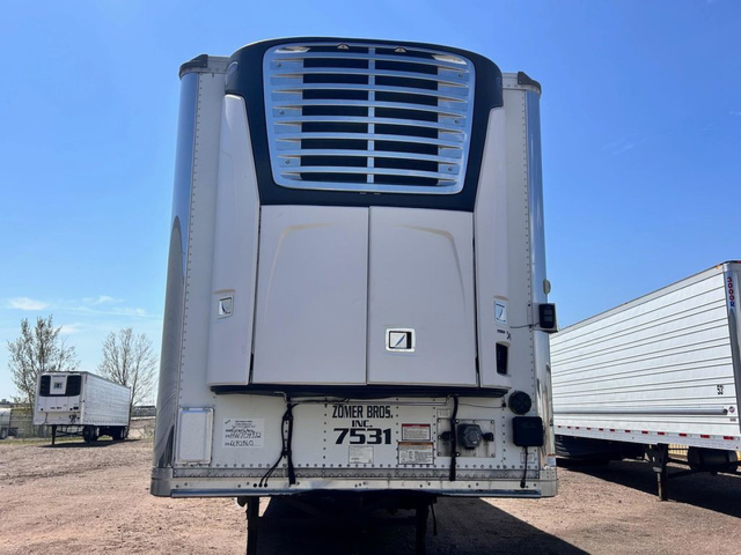 Great Dane reefer trailer rear view showing cooling unit, bumper, and license plate area.