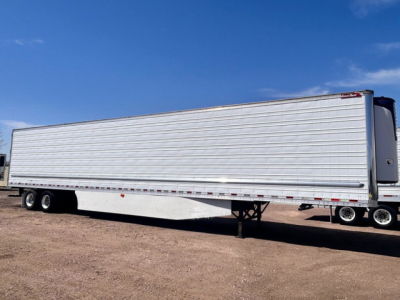 Great Dane refrigerated trailer showing exterior side with tandem rear wheels and landing gear.