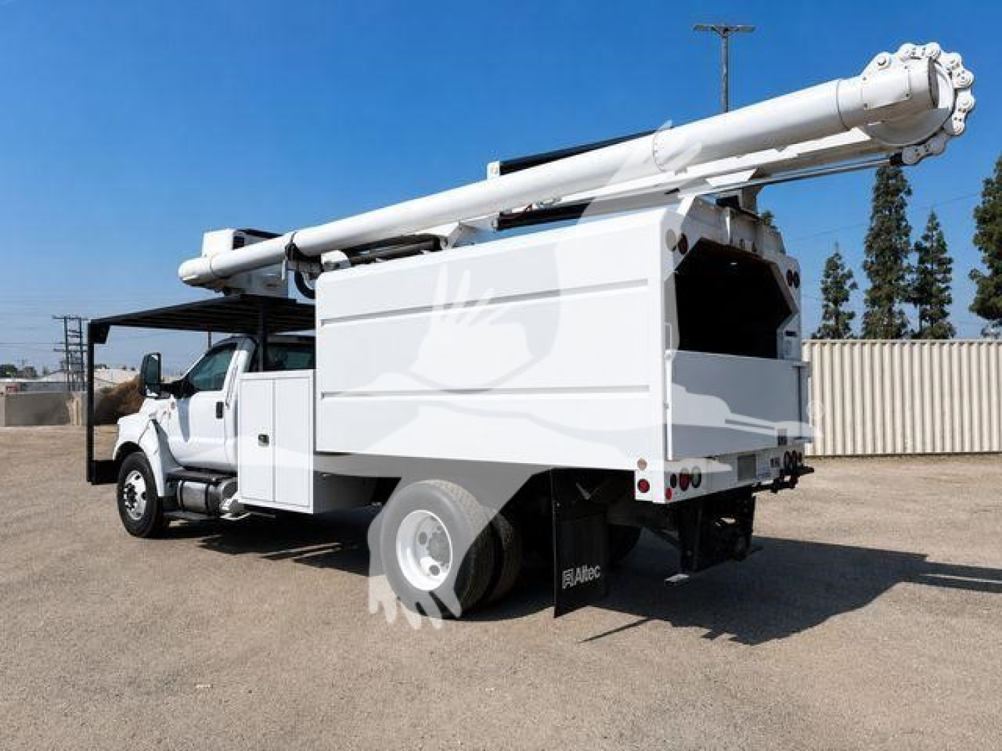 Ford F-750 bucket truck with boom extended, side view showing utility body and white cab.