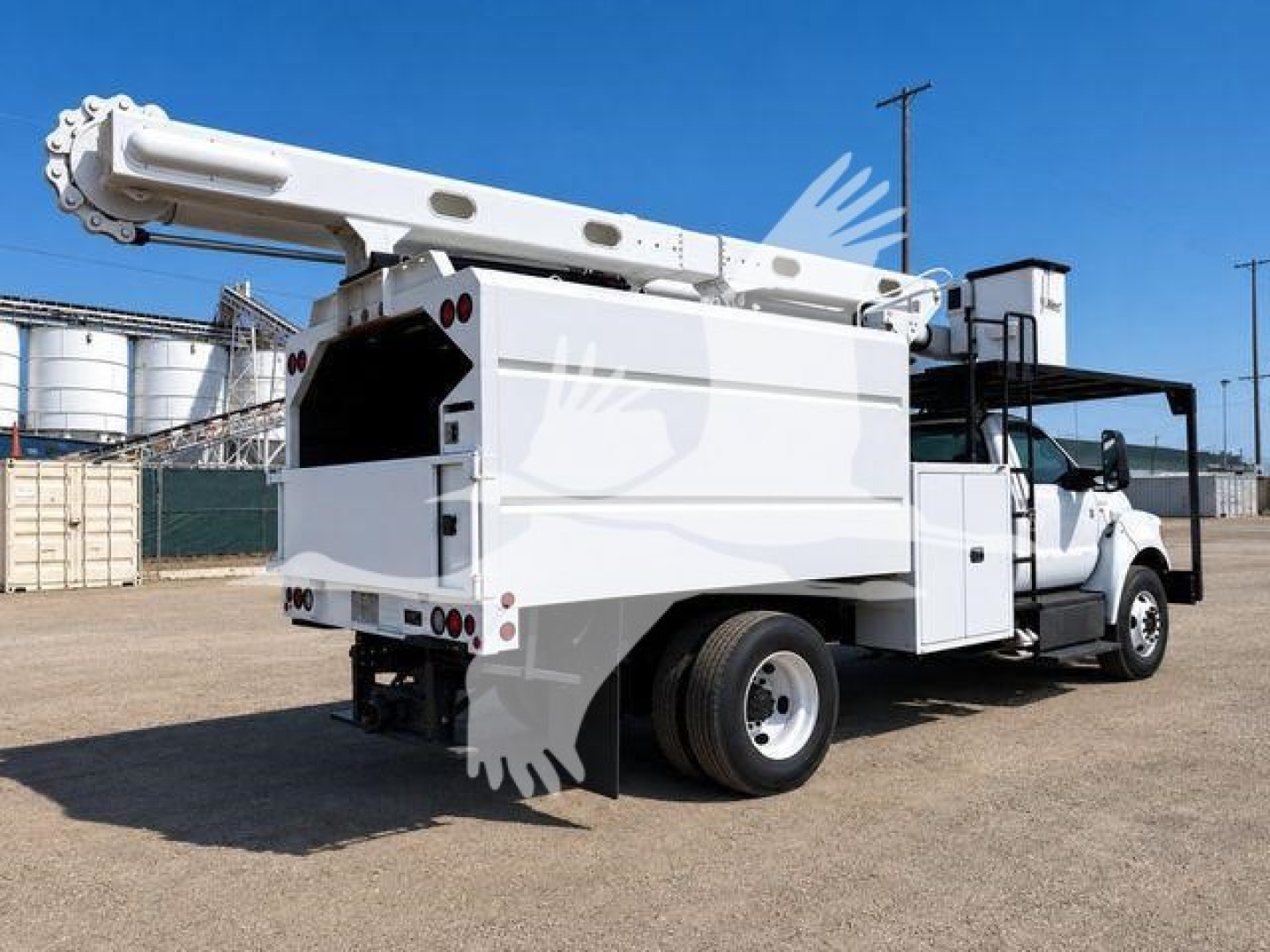Truck rear/side view showing bucket lift and utility body on a Ford F-750 XL SD, white with hydraulic boom extended, rear view highlights buckets and compartments.