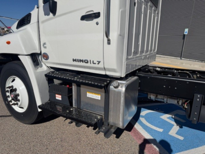Truck cab and chassis showing HINO L7 badge with toolbox and steps attached under cab