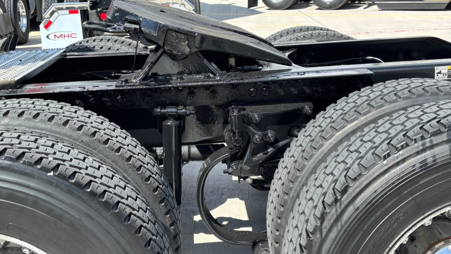 Peterbilt 579 chassis view showing dual rear tandem and suspension components with tires, frame rails, and hitch area.