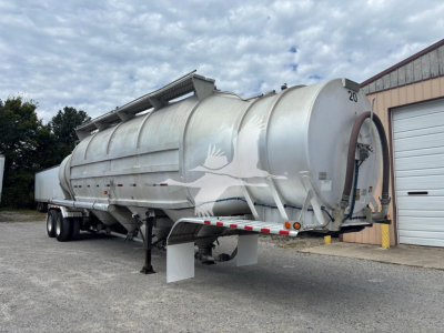 Trailer showing hull with rounded cylindrical tank and rear hoist for Heil 1625 Super Flo pneumatic-dry bulk trailer, silver/metallic finish, number 20.