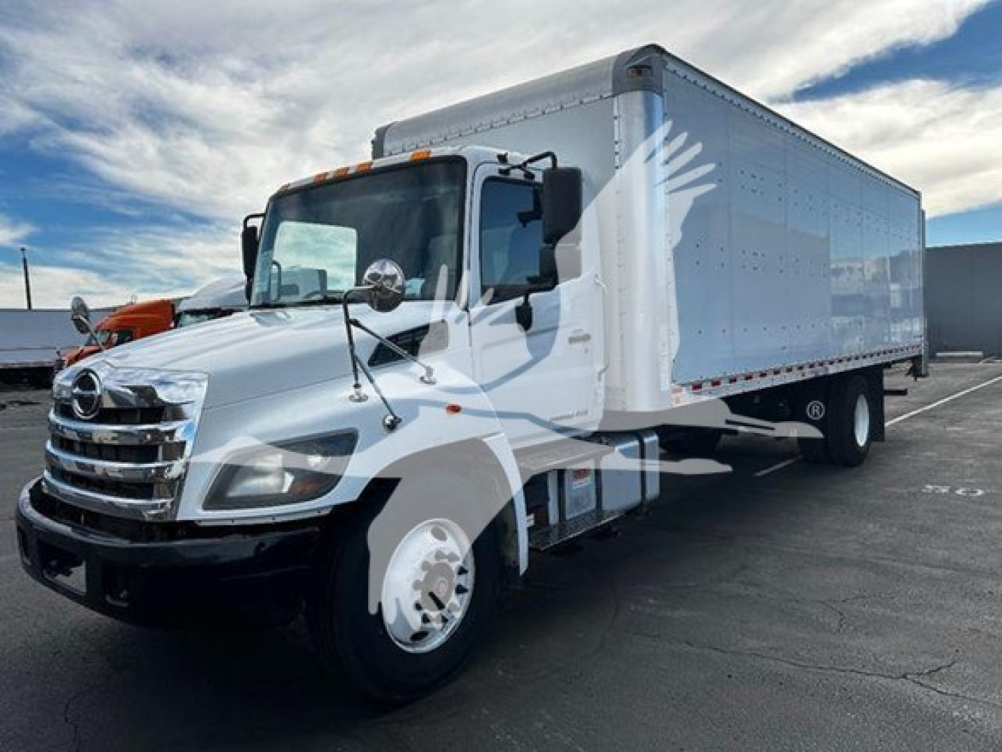 Hino 268a box truck in service showing white cab and large aluminum cargo box.
