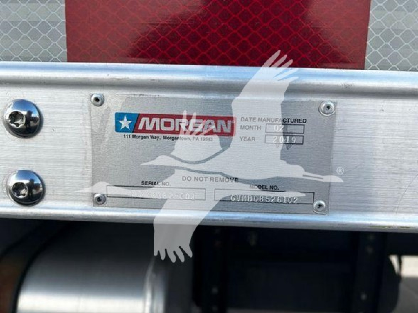 Truck equipment label on silver panel showing Mor-sem company logo, VIN and serial numbers; text includes 'DATE MANUFACTURED' and model details on a metal plate.