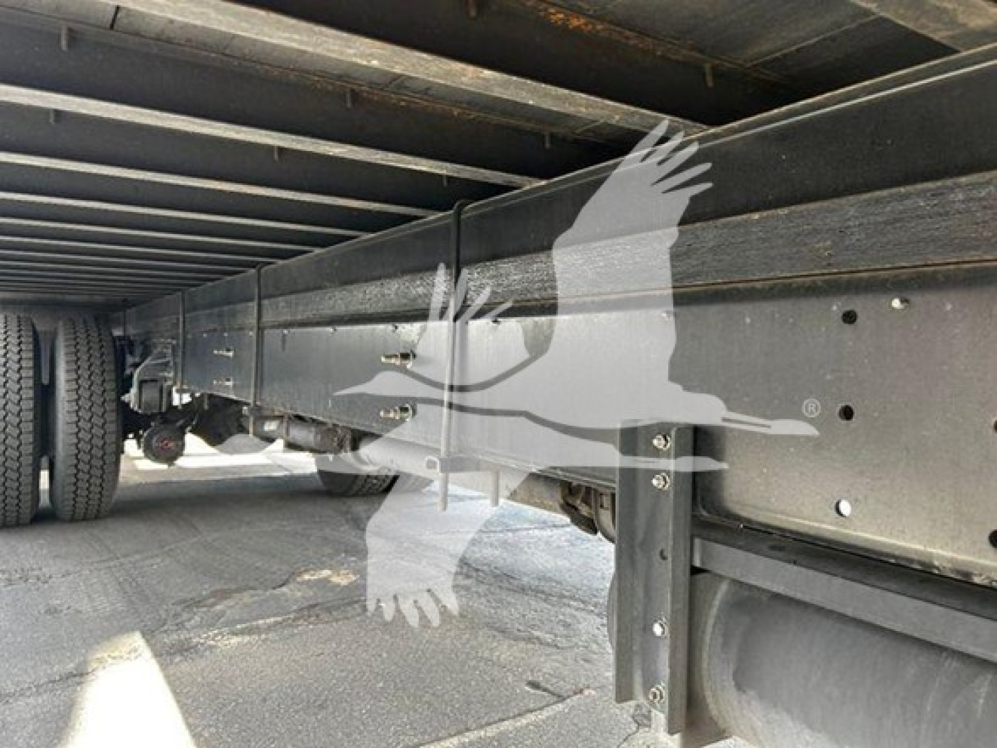 Underbody view of a 2020 Hino 268a box truck showing the chassis rails and frame with components near the wheel, no text visible.