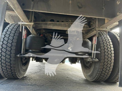 Underfront view of a Hino 268a truck showing rear suspension with air springs and dual tires.
