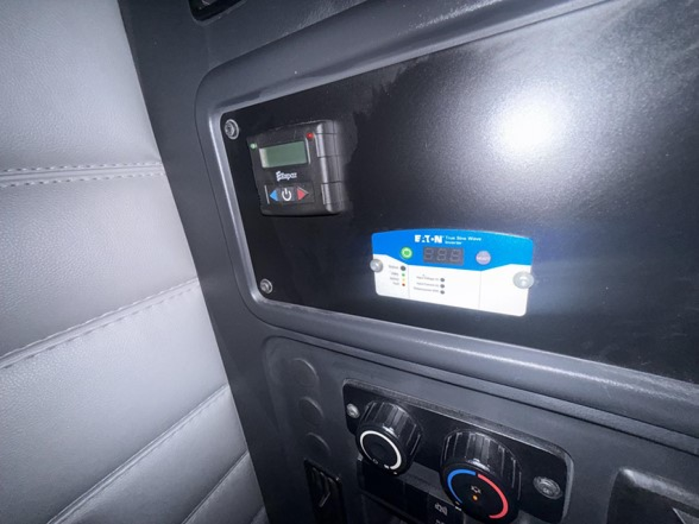 Cab interior showing dashboard controls and a blue PCI card holder area in a Freightliner Cascadia 126 truck.