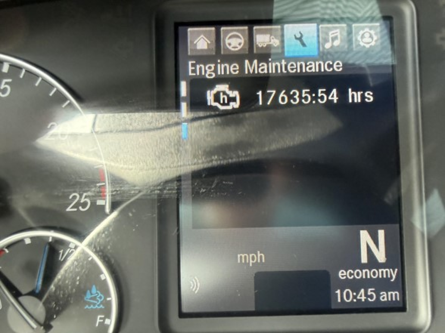 Dashboard of a Freightliner Cascadia 126 showing engine maintenance screen with 17635:54 hrs remaining, N for neutral, mph gauge, and time 10:45 am.