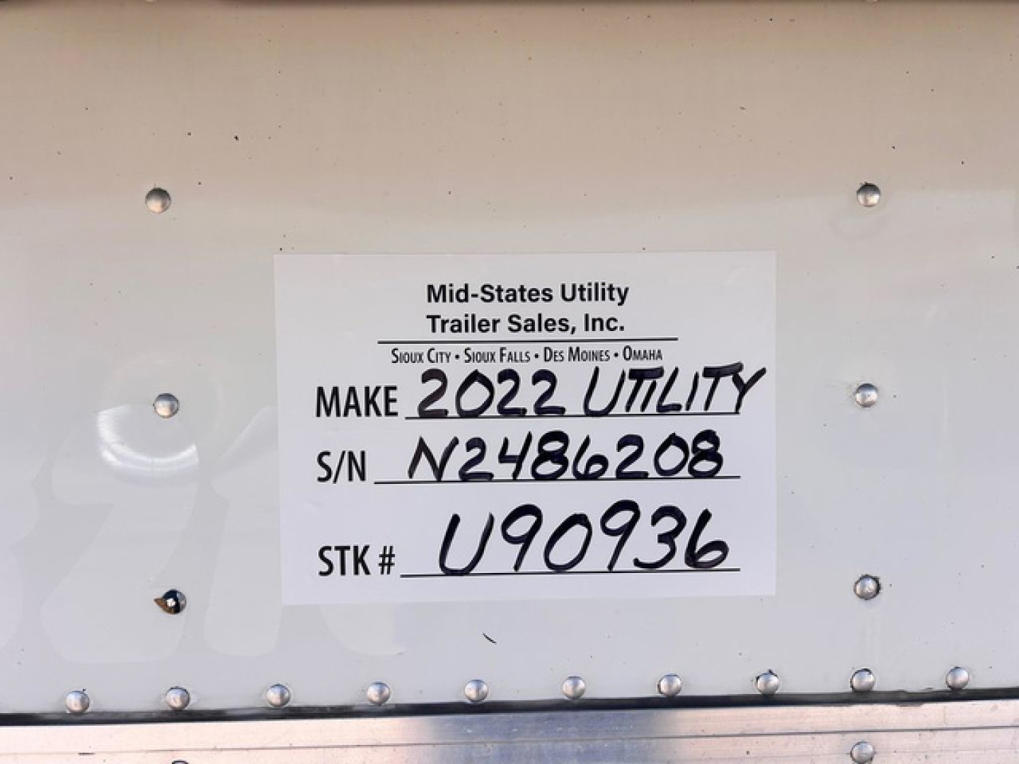 Label plate on mid-states utility trailer showing Make 2022 Utility, S/N N2486208, STK# U90936, trailer sold by Mid-States Utility Trailer Sales, Inc.