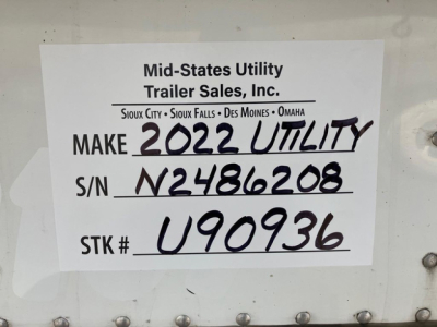 Sign on a trailer showing Make 2022 Utility, S/N N2486208, Stock U90936 with MT signage. Handwritten: MAKE 2022 UTILITY, S/N N2486208, S/TK # U90936.