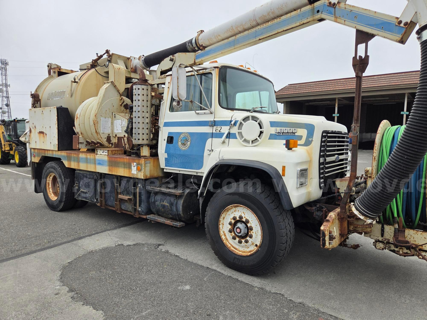1992 Ford LN8000 vacuum truck showing front grille and hose reel assembly.