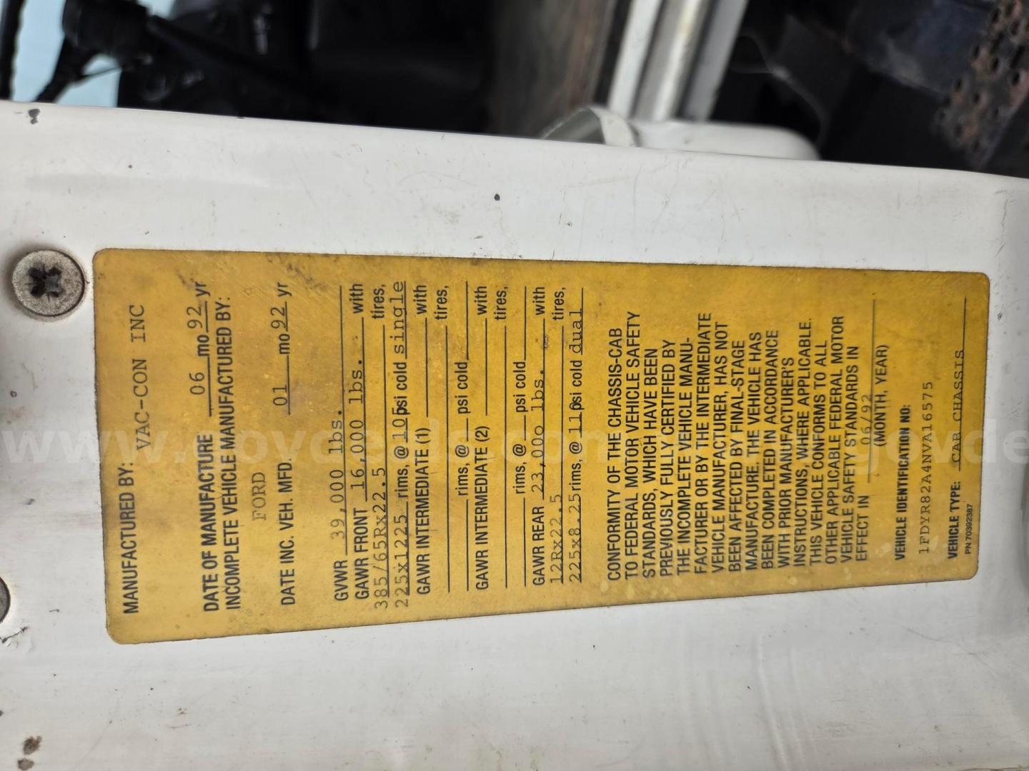 Identification label on Ford LN8000 truck door jamb with VIN and manufacturing data printed in black text on yellow background.