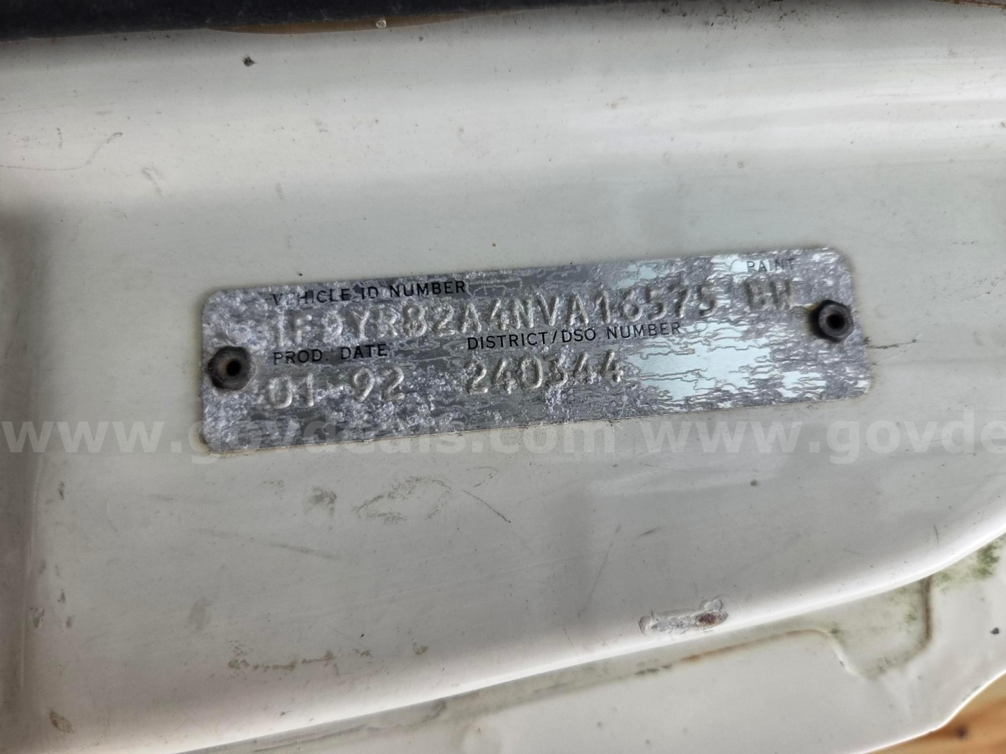 Plate with VIN and year information on Ford LN8000 cab area showing number and dates.