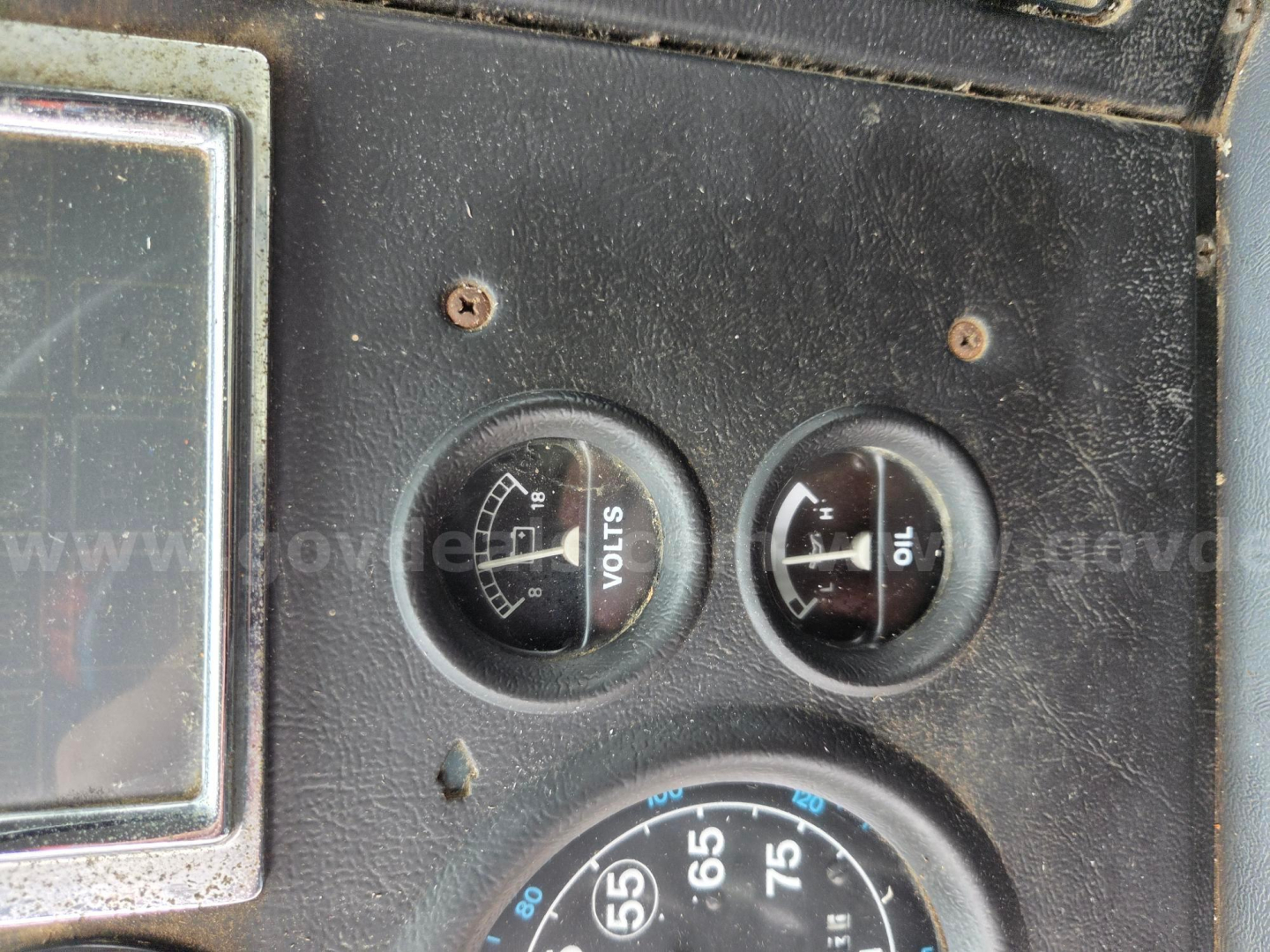 Ford LN8000F dash gauges showing voltmeter and ammeter and large speedometer/engine gauges.