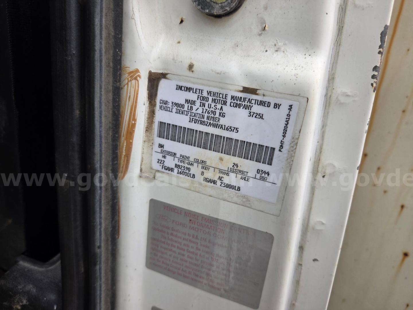 Label on door jamb with VIN and vehicle info for a 1992 Ford LN8000F vacuum truck; includes incomplete vehicle ID, manufacturer details, and barcodes.