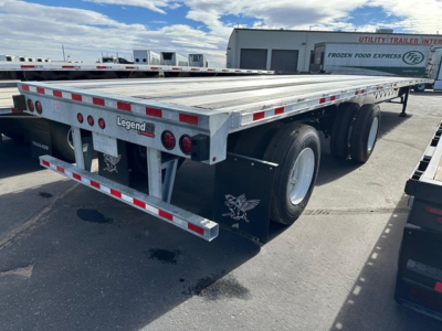 Flatbed trailer with tandem axles showing Legend SII branding and silver aluminum deck; rear bumper, lights, and safety rails visible.