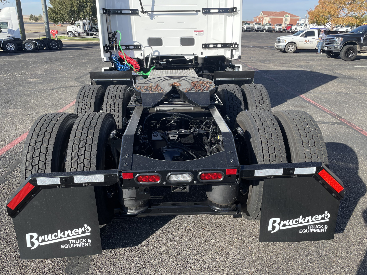 Rear view of a Mack PR64T64 tractor chassis showing dual rear axles, fifth-wheel area, and mud flaps with Bruckner's Truck & Equipment logos.