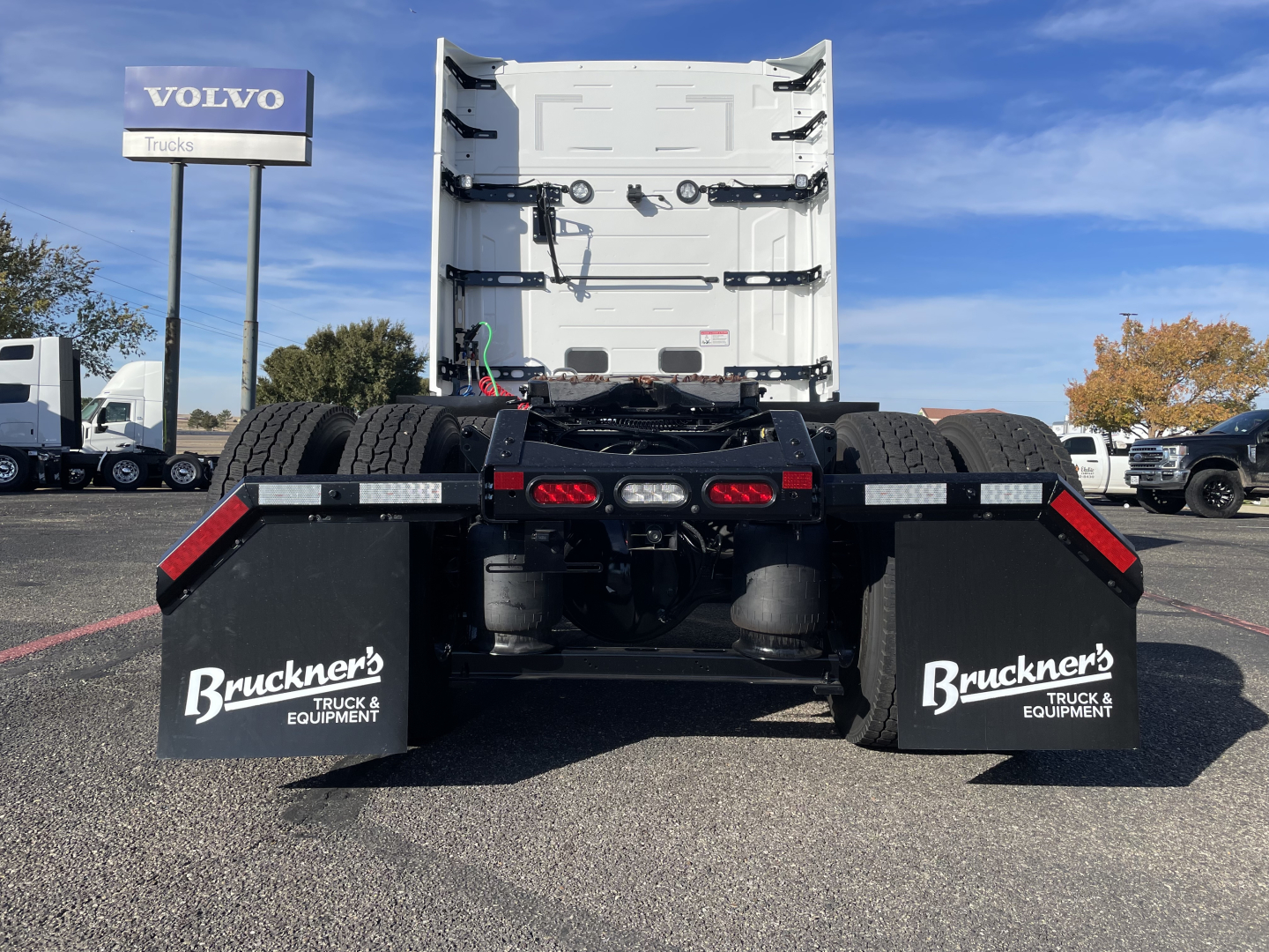 Mack PR64T64 concrete sleeper truck rear view showing dual rear axles and mudflaps with Bruckner's branding.