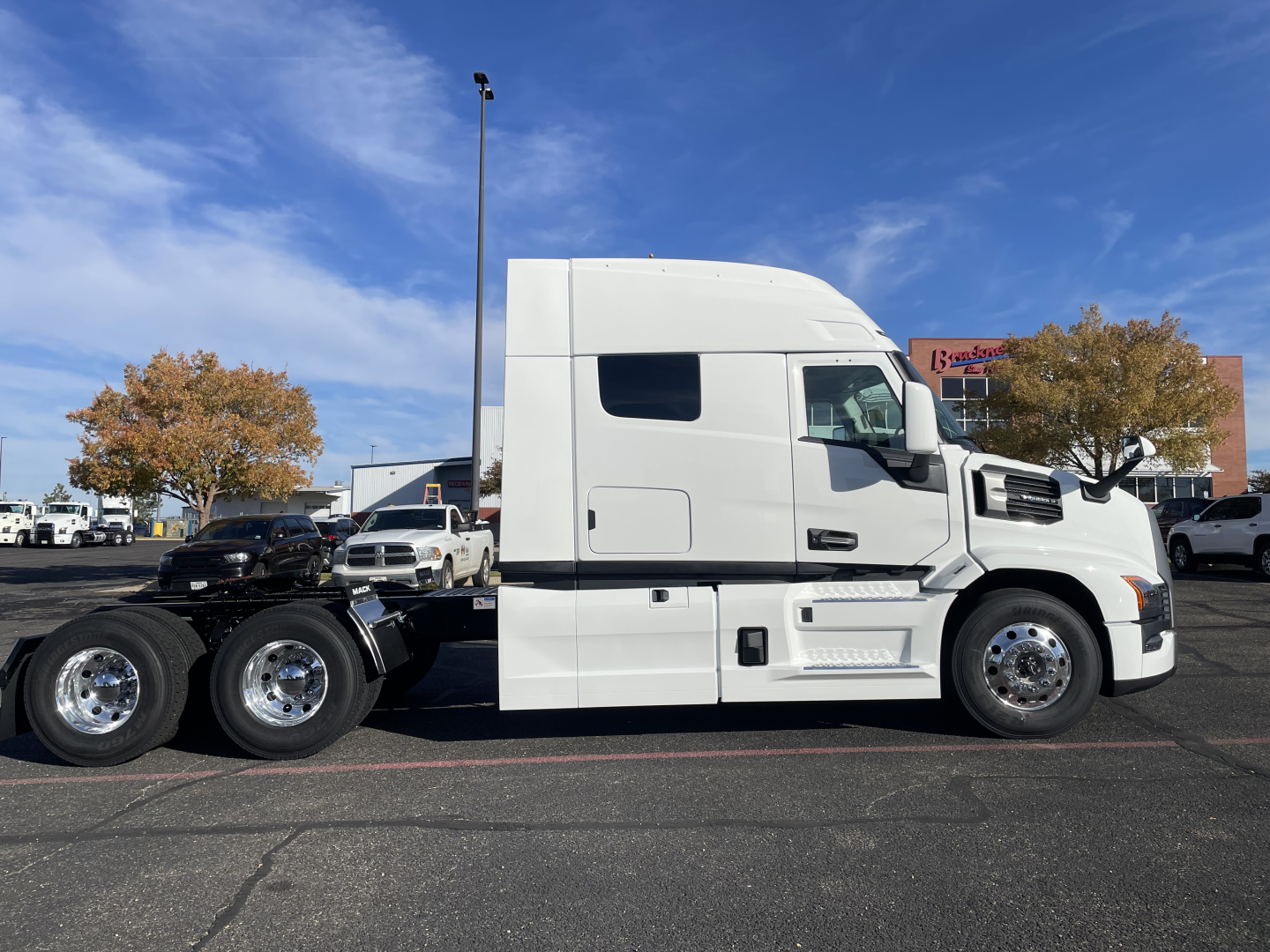 2026 Mack PR64T64 conventional sleeper truck side view showing cab, fuel doors, and wheels.