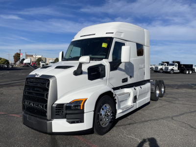 Mack PR64T64 conventional sleeper truck side view showing white exterior, large grille, aerodynamic mirrors, and dual rear axles.