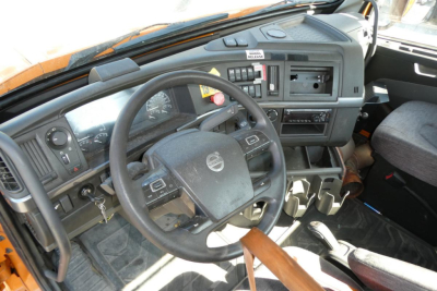 Volvo VNR64T300 truck cab interior showing steering wheel and dashboard with gauges and controls.