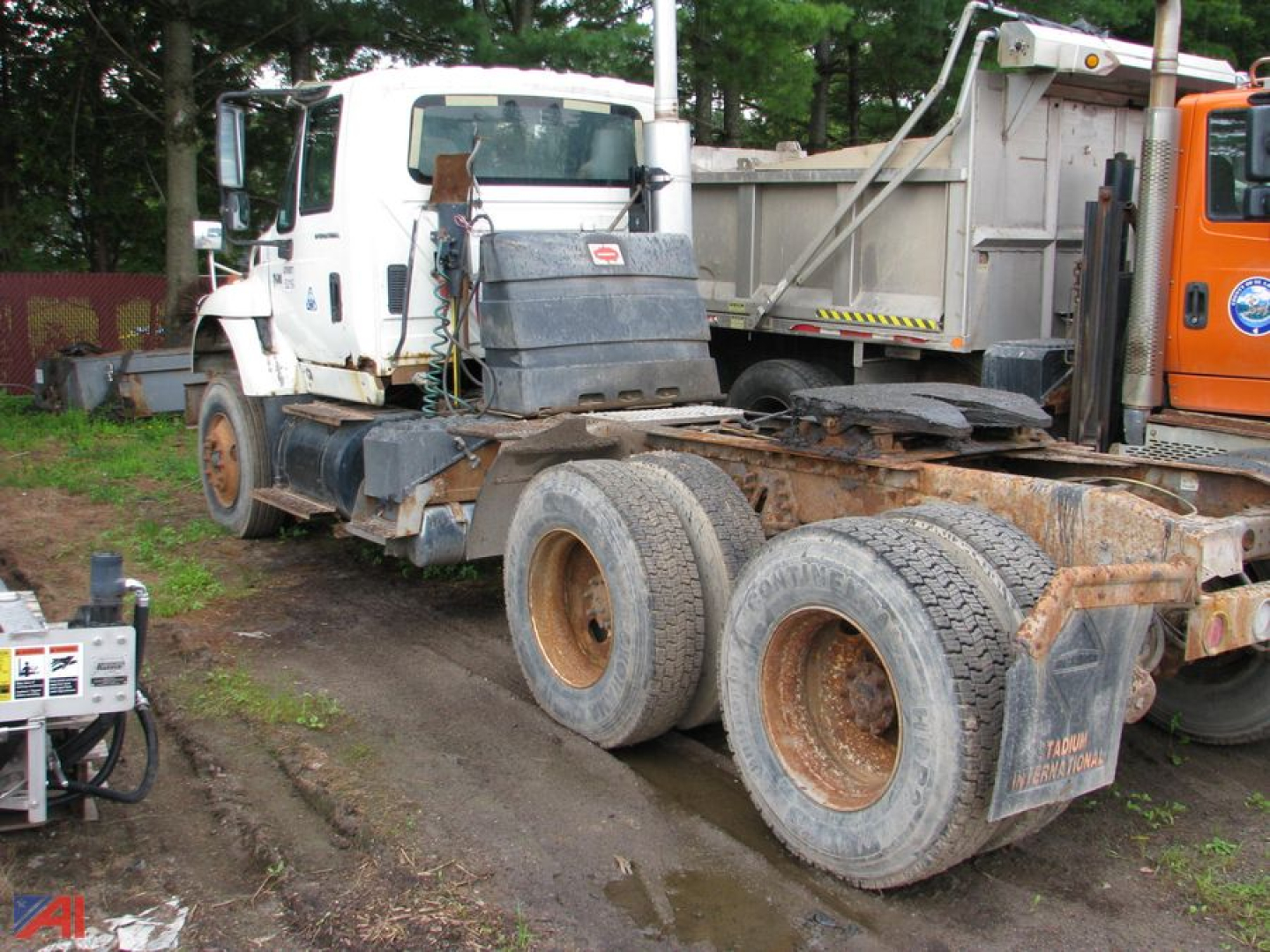 Truck tractor cab with attached mudflaps and dual rear axles showing rust and mud; International SF547 WorkStar 7600 listing.