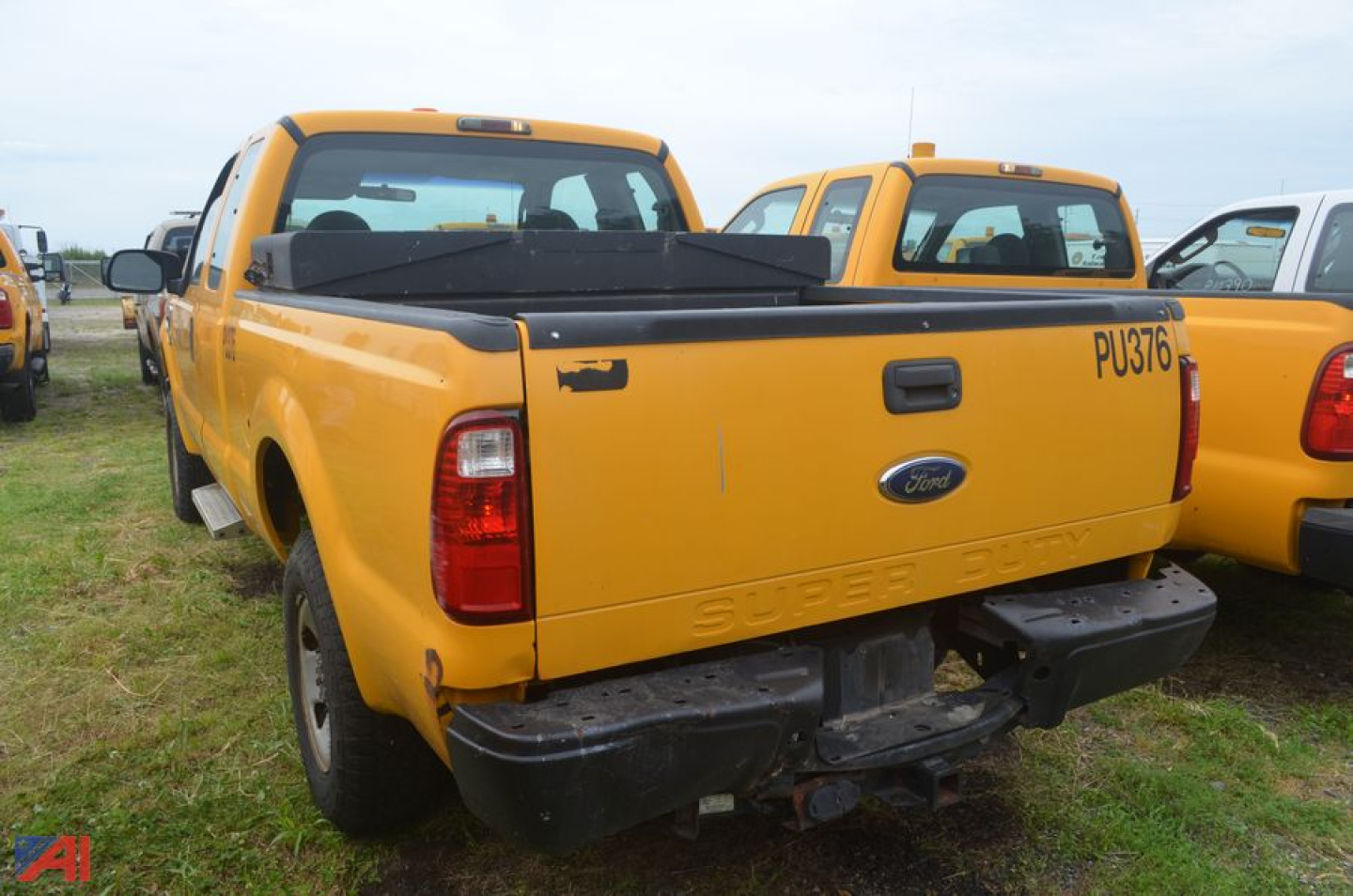 Ford F-250 Super Duty pickup truck tailgate and rear bumper in yellow, extended cab, 2008 model year, with tail lights and rear hitch visible.